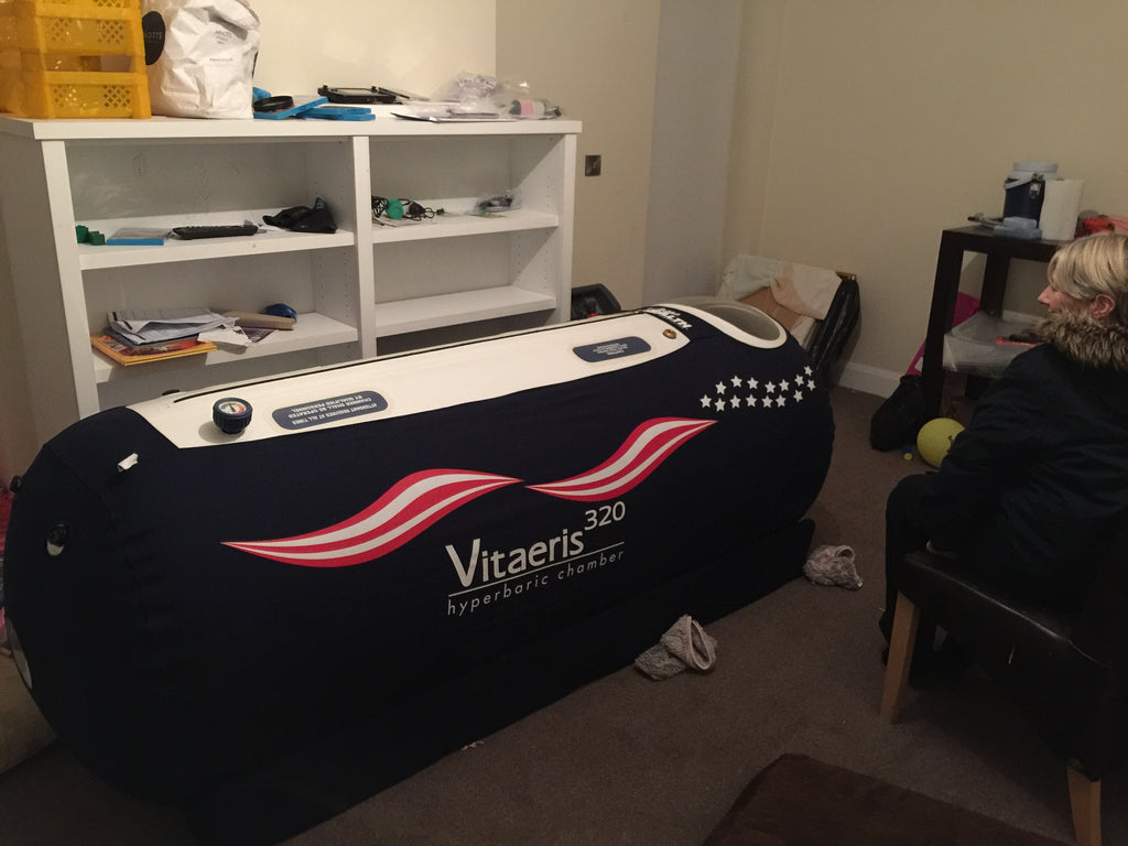 Inflatable hyperbaric chamber with 'Vitaeris' branding in a room setting.