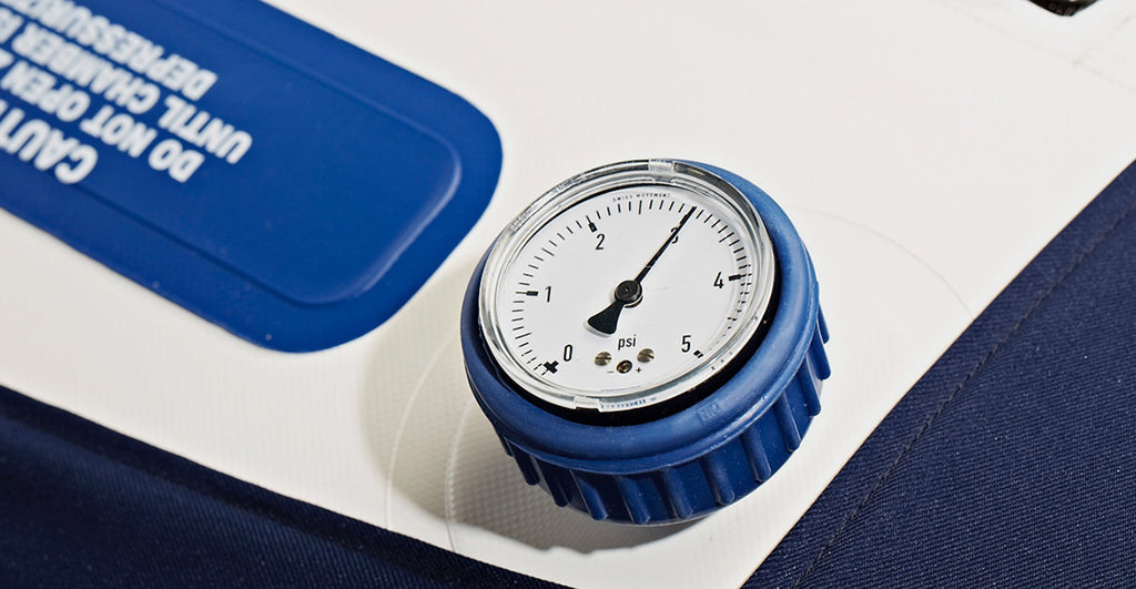Pressure gauge on a piece of equipment with blue and white design