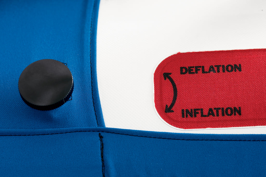 Close-up of a blue and white inflatable device with a red label indicating 'Deflation' and 'Inflation'.