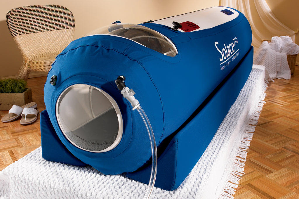 Blue hyperbaric oxygen chamber labeled 'Solara' on a wooden floor.