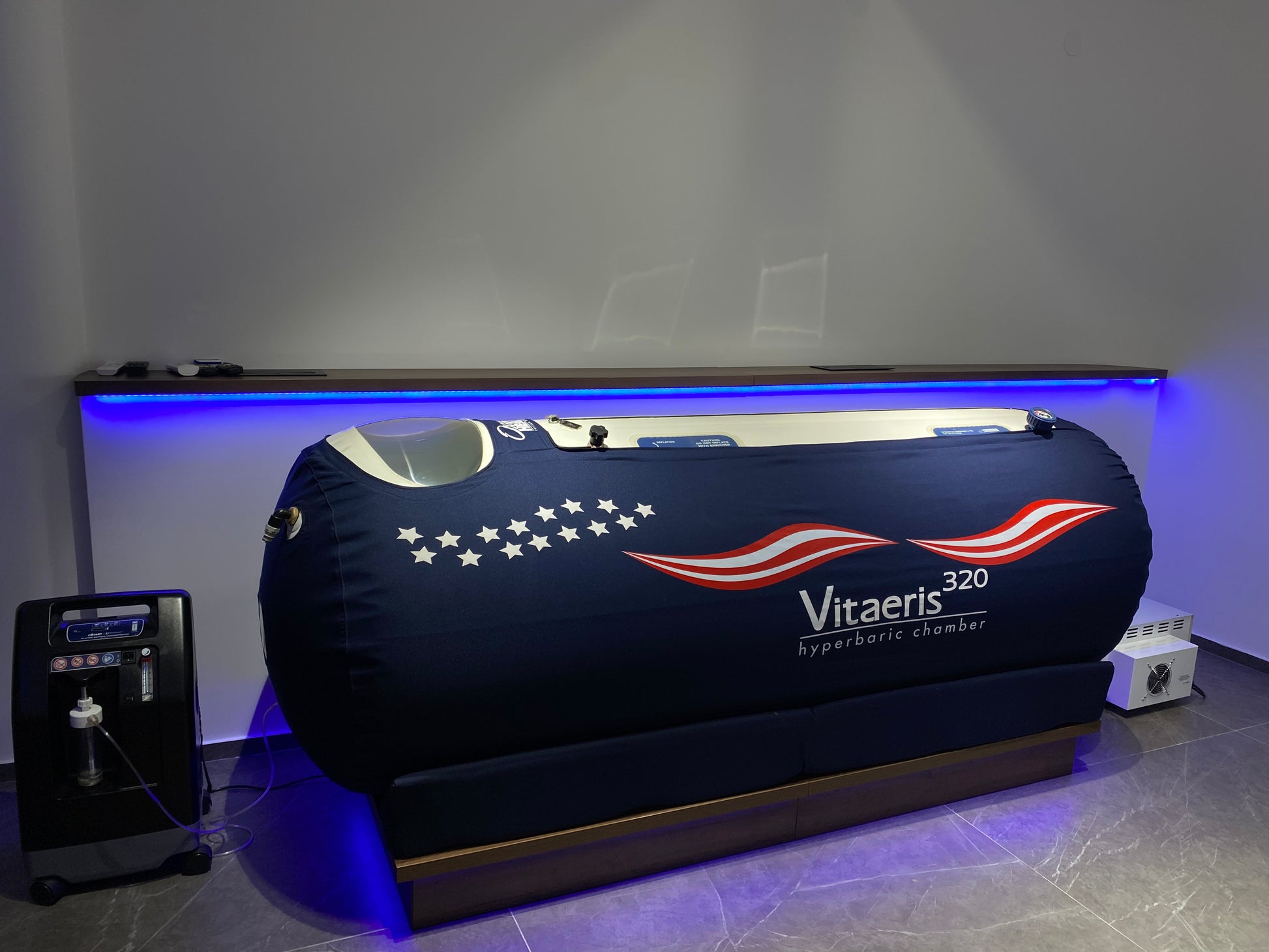 Vitaeris 320 hyperbaric chamber with American flag design in a room setting.