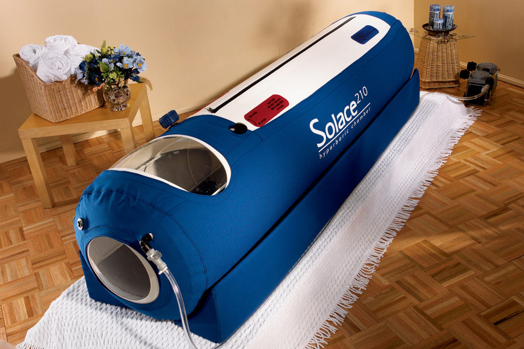 Blue Solace 210 hydrotherapy barrel on a wooden floor with a beige wall in the background.